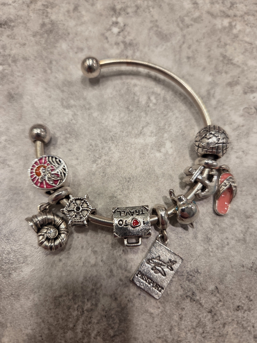 Silver Travel Charm Bangle Bracelet with Coral Accent